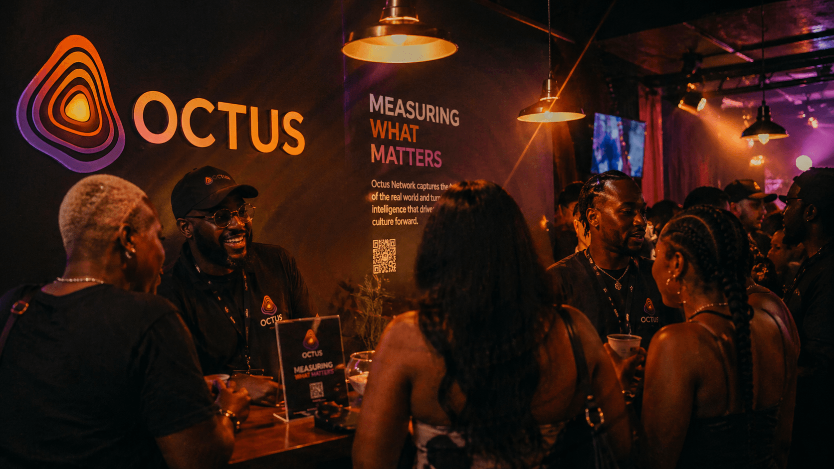 Octus Network booth at a cultural event with attendees